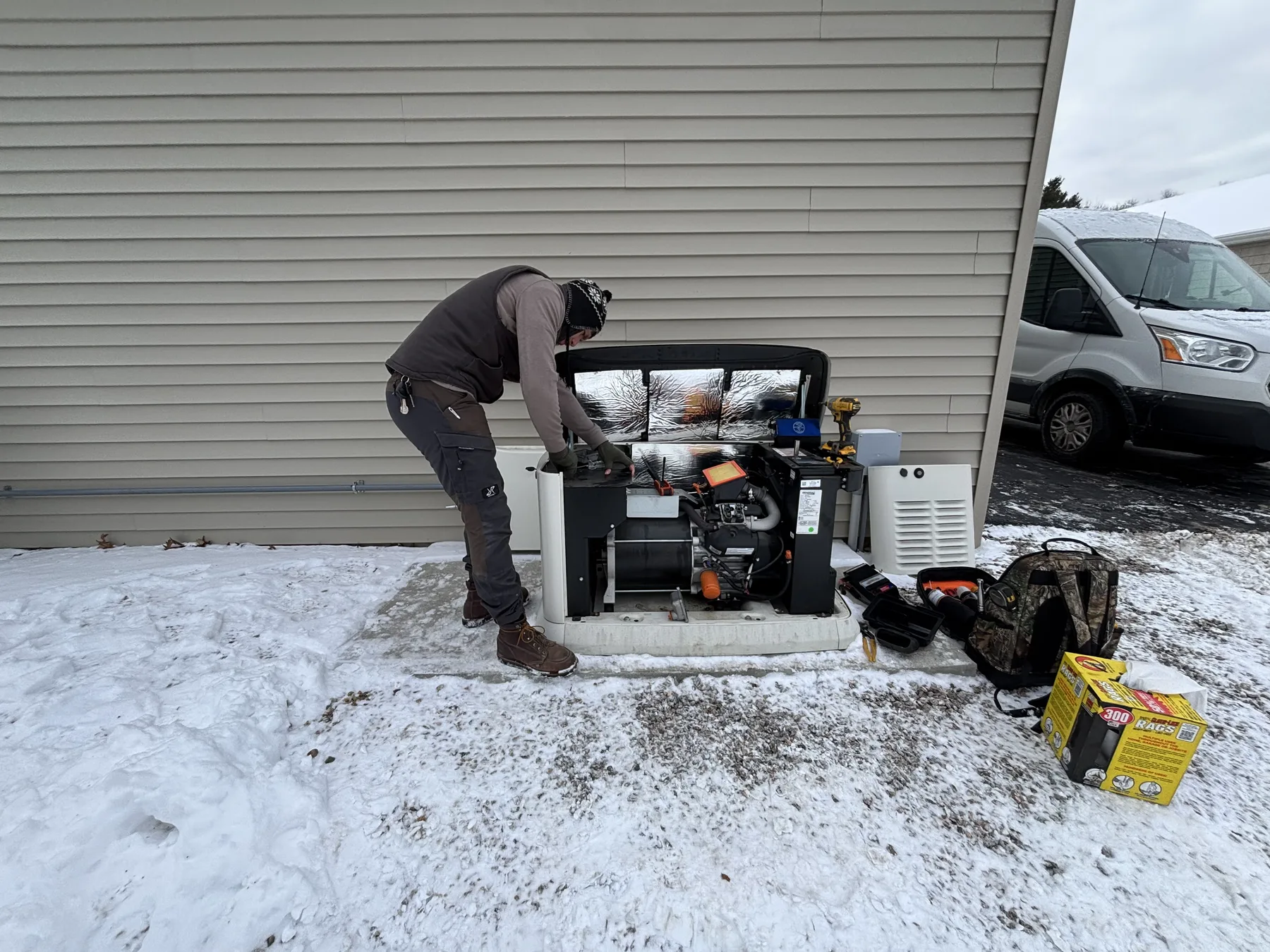 Winter service call, technician working on Generac unit